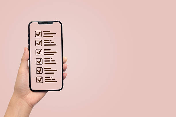 istock A hand holding a smartphone displaying a checklist with ticked items. 2224188823