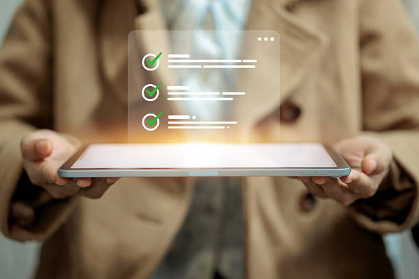 istock A person in a brown coat holds a tablet with a glowing digital checklist, representing productivity, online task management, or organization. 2224188915