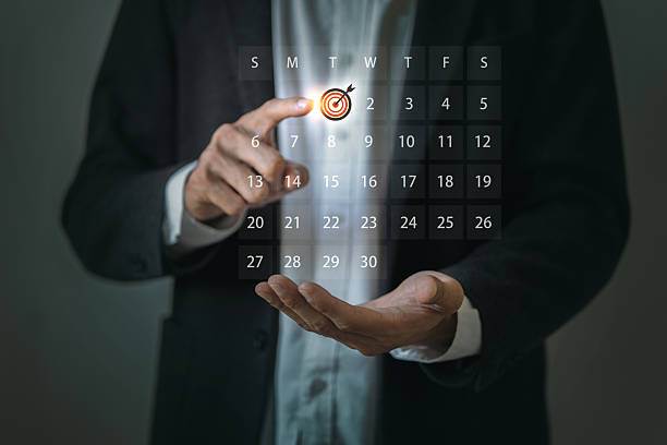 istock A business professional selecting a date with a target icon on a digital calendar interface floating above his hand. 2224189208