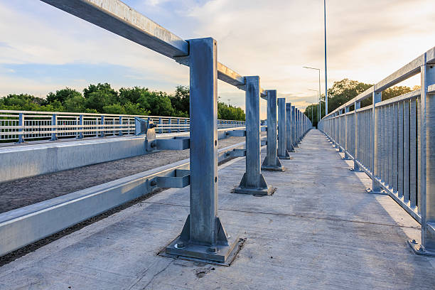 istock Modern steel bridge in scenic park setting with sunset sky 2224194867