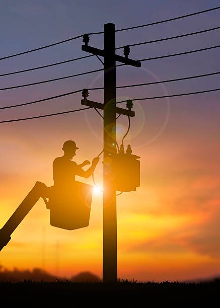 istock Electrician Working on Power Lines at Sunset 2224194913