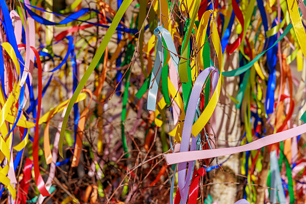 istock Vibrant multicolored ribbons decorating branches in a festive outdoor setting 2224194932