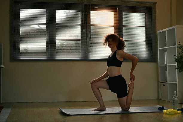 istock Morning workout routine with a fit woman practicing yoga at home 2224195482