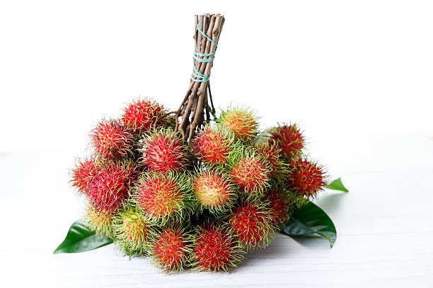 istock Fresh rambutan fruit on white wooden table. 2224199841