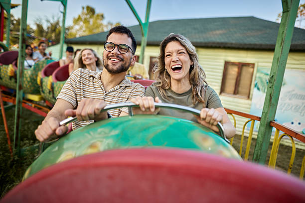 istock Young happy couple having fun on rollercoaster at amusement park. 2224204494