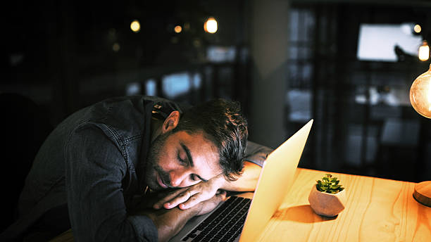 istock Laptop, businessman and sleeping in night office for research, copywriting deadline or project. Creative worker, writer or editor with fatigue, burnout or exhausted for editing news article online 2224204975