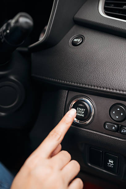 istock Finger pointing at a start stop engine button in a modern car interior, showcasing keyless ignition. 2224206319