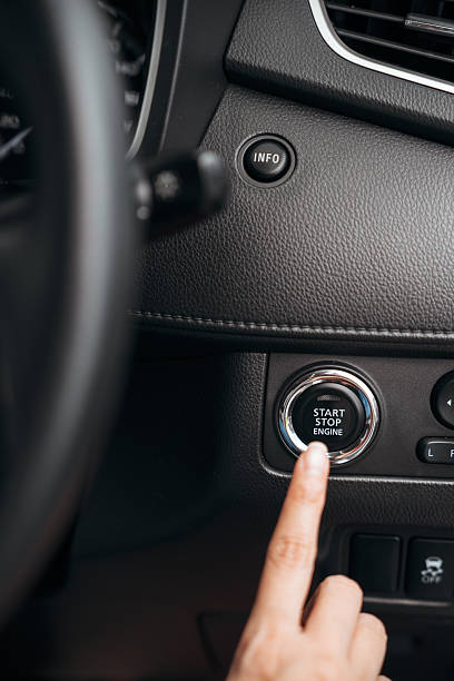 istock Finger pointing at a start stop engine button in a modern car interior, showcasing keyless ignition. 2224206329