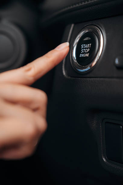 istock Finger pointing at a start stop engine button in a modern car interior, showcasing keyless ignition. 2224206332