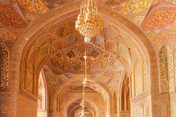 Inside Masjid Wazir Khan, vibrant tilework, floral motifs, and symmetrical arches create a serene space of worship, rich in cultural heritage and spiritual ambiance.