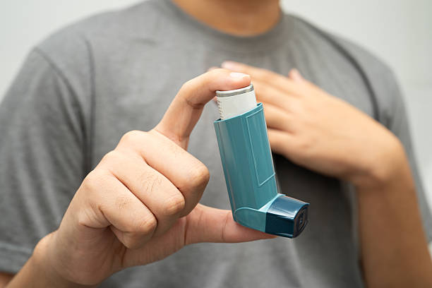 istock Asthma and chronic obstructive pulmonary disease COPD, Asian young man using metered dose inhaler MDI. 2224210086