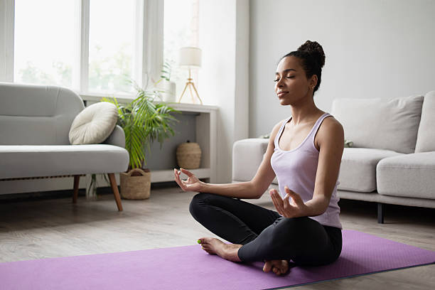 istock Woman practicing yoga, doing relaxation exercises, meditating at home 2224210377