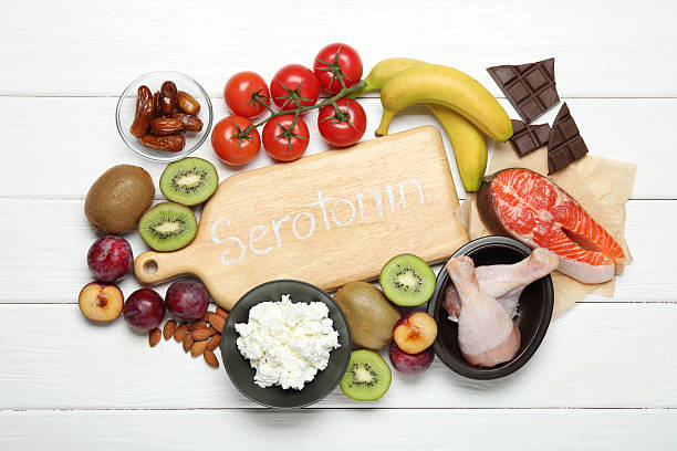 istock Wooden board with word Serotonin and different fresh products on white table, flat lay 2224210740