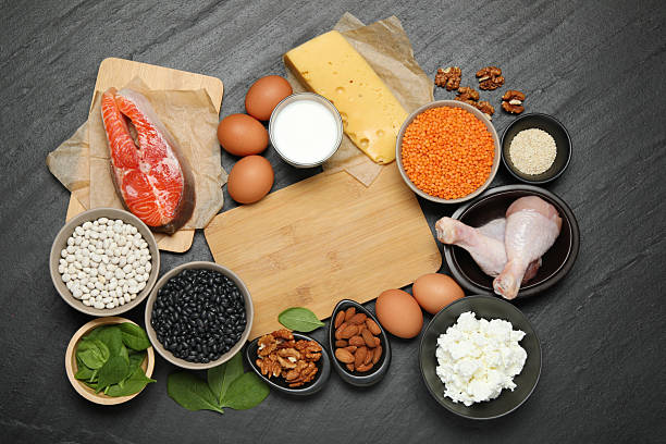 istock Different fresh products rich in estrogen and wooden board on grey textured table, flat lay 2224210745