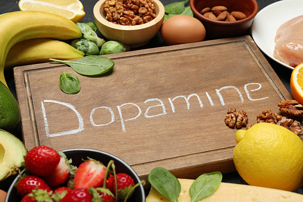 istock Wooden board with word Dopamine and different fresh products on grey table 2224210768
