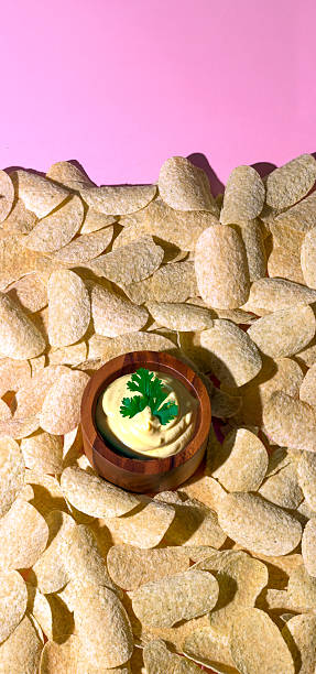 istock Potato Chips and Creamy Dip on Pink Background 2224212009