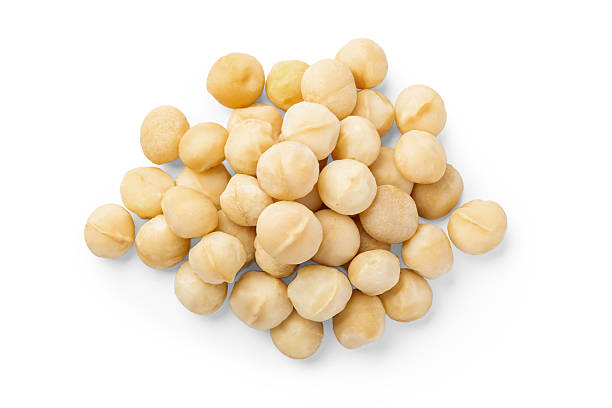 istock Heap of macadamia isolated on white background 2224215419