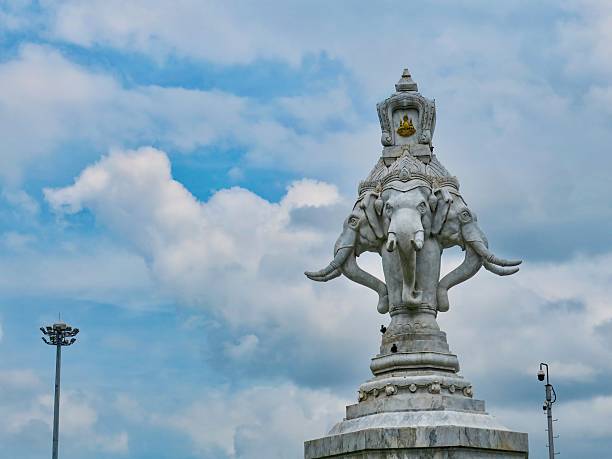 Glass elephant against a blue cloudy sky