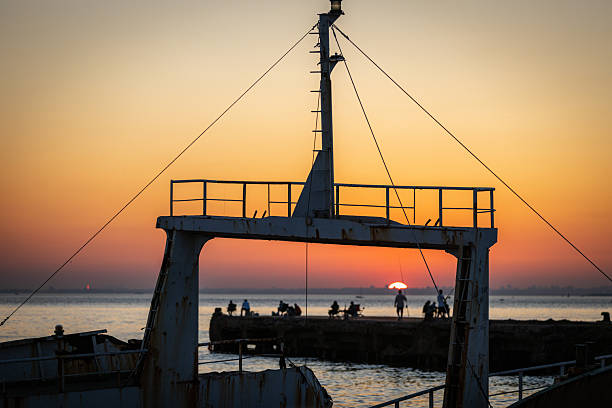 Old medieval sailing ship in sunset on the open sea.