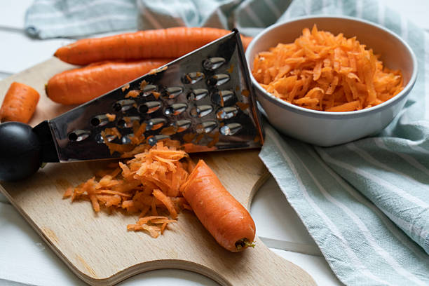 Fresh organic shredded carrots on cutting board
