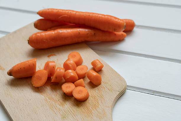 Freshly sliced organic carrots on cutting board