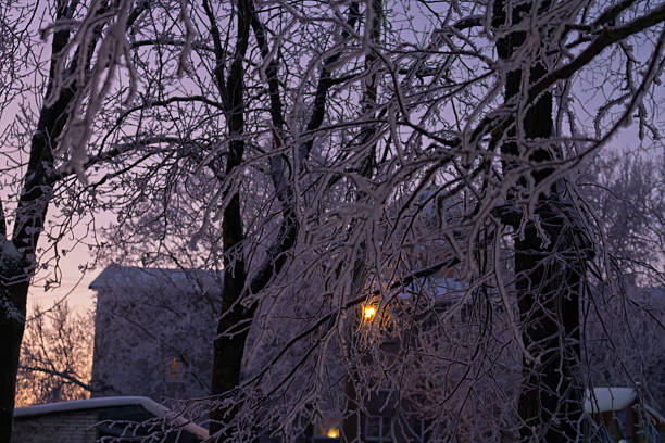 Frost pattern on window with glimpse of sunset outdoor behind crystals