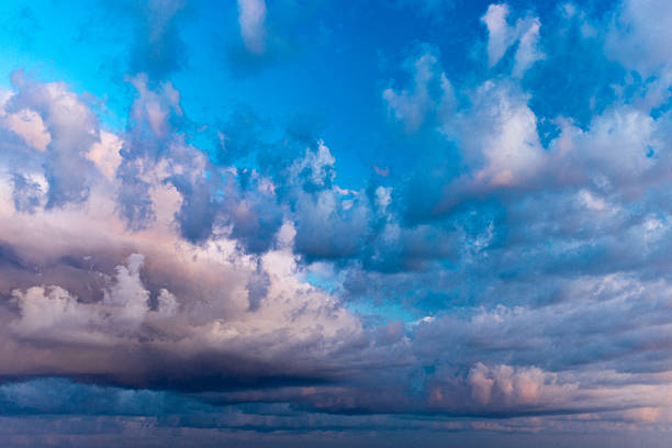 Serene sunset scenery featuring a vibrant mixture of colorful clouds and a vivid sky, evoking calm and tranquility, suitable as a background for peaceful designs or tranquil imagery.