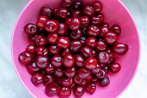 istock washed cherries in a pink plastic bowl 2224220979
