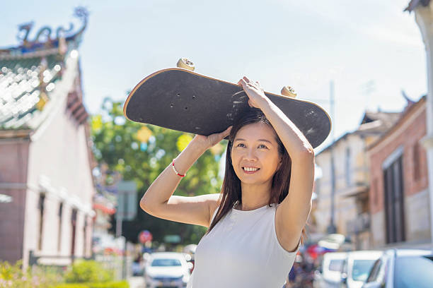 istock Woman chill walk with skateboard in hands 2224221602