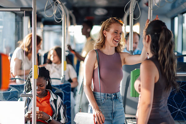 istock Two young women talking and laughing on a bus 2224225468
