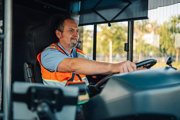 istock Bus driver steering wheel and looking out window 2224225788
