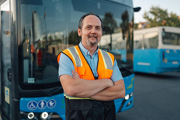 istock Bus driver smiling with crossed arms in bus depot 2224225821