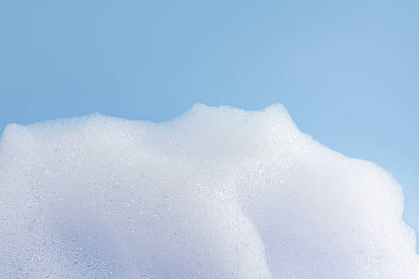 istock Texture of white bubble bath, soap, laundry detergent on a blue background. Layout for the presentation of your cosmetic product. 2224226225