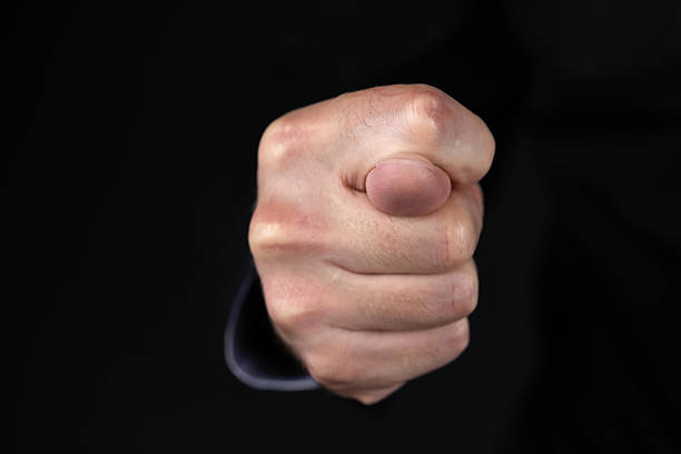 istock Fig sign. Fig gesture in the dark 2224227214