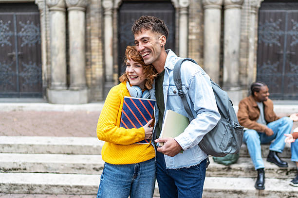istock Happy students hugging outside university building 2224230605