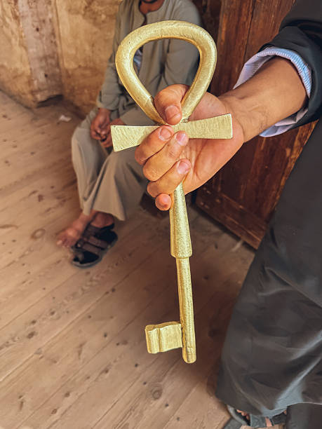 Tour guide holding a golden ankh key inside an ancient egyptian temple