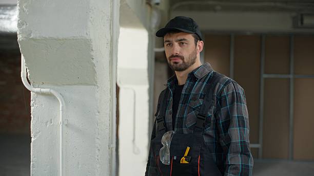 istock Builder engineer wearing gloves safety construction Caucasian man architect foreman master in uniform start work building site male guy electrician handyman repairman industrial job safety rules build 2224231373