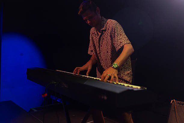 istock A talented musician playing an electronic keyboard. The image captures the focus and movement during a live musical performance 2224231641
