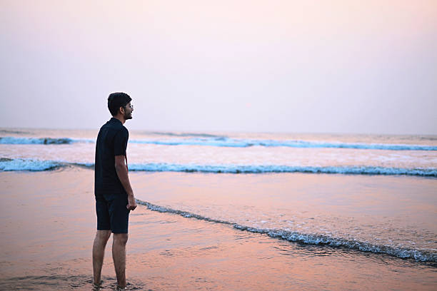 istock Young Man Having a Solitary Sunset Beach Walk 2224234870