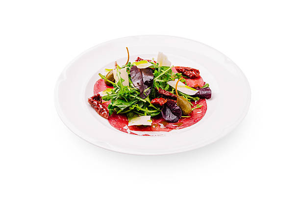 istock Fresh salad with beef carpaccio and mixed greens served on a white plate 2224235456