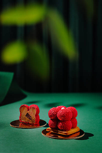 istock Desserts with vibrant red toppings on a green background under soft lighting 2224235730