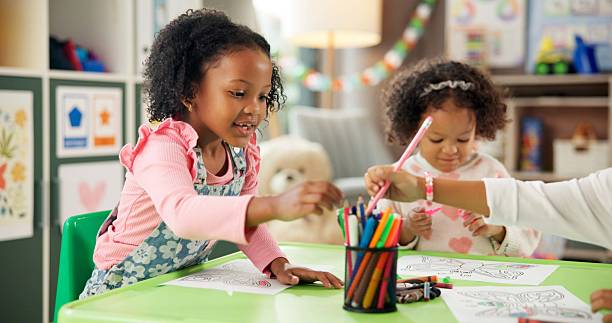 istock Creative, kindergarten and drawing with girl in classroom for child development, artwork and color project. Friends, academy and growth with students at school for knowledge, learning and education 2224235759
