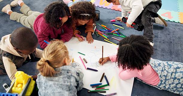istock Color, above and drawing with kids in classroom for child development, artwork and creative project. Youth, academy and growth with students at school for knowledge, learning and kindergarten 2224235803