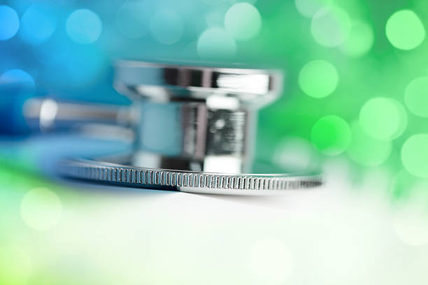 Midsection Of Female Doctor With Stethoscope Against White Background