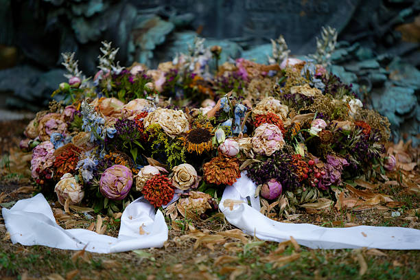 Rose on tombstone. Red and White  roses on grave. Love - loss. Flower on memorial stone close up. Tragedy and sorrow for the loss of a loved one. Memory. Gravestone with withered rose