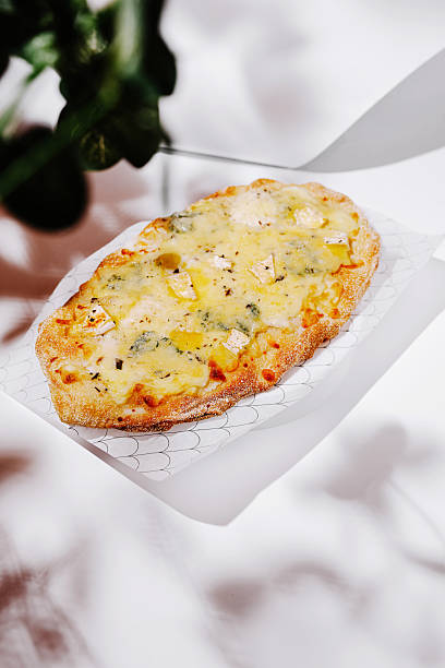 istock Delicious flatbread topped with cheese and herbs served on a plate 2224236255