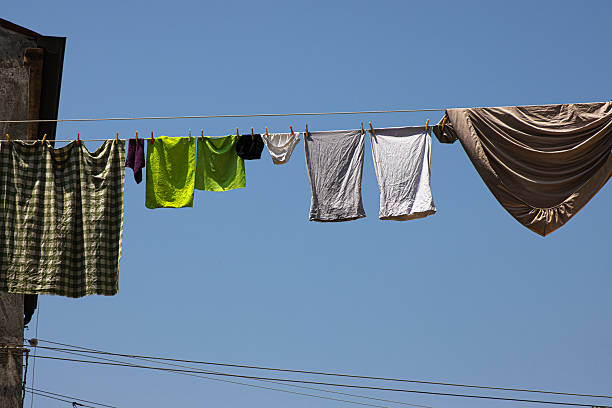 Paudalho, Pernambuco, Brazil:Young woman hanging laundry on the clothesline