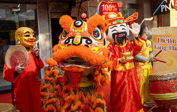 A group of Vietnamese actors and musicians in colourful costumes perform a traditional lion dance for a business as it reopens after Tet, or the lunar new year, in Hanoi, Vietnam.