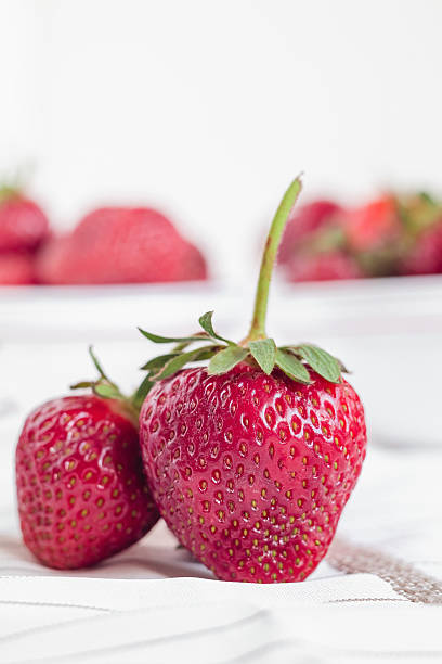 istock Fresh red strawberry close up on a white table. 2224244802