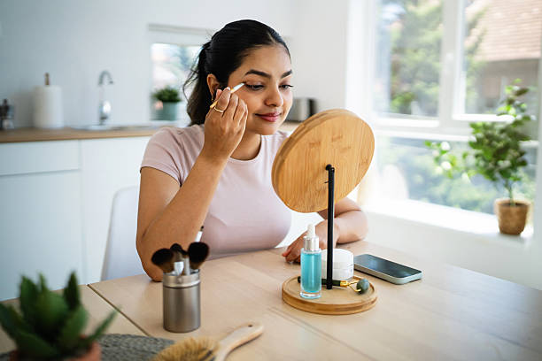 istock Young Indian woman is doing her makeup at home 2224246589